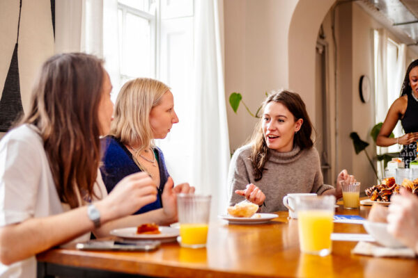 Gather Round members around the kitchen table at the breakfast